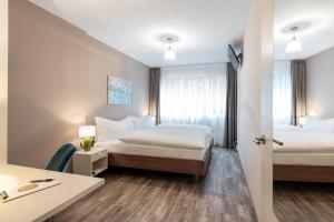 Postelja oz. postelje v sobi nastanitve Hotel Birsighof Basel City Center
