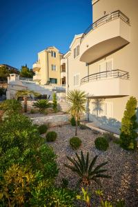 a view of the house from the garden at Apartments Vrania in Seget Vranjica