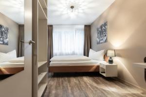 Postelja oz. postelje v sobi nastanitve Hotel Birsighof Basel City Center