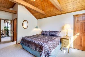 a bedroom with a bed and a wooden ceiling at Wren Ridge in Pagosa Springs