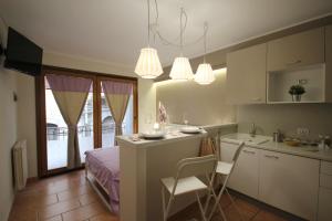 a kitchen with a counter and a kitchen with a table at Cortile Aurora Bronte in Bronte +36 photos
