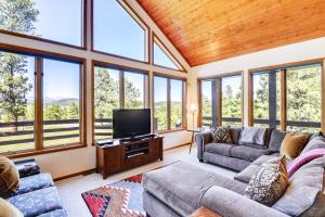 a living room with couches and a flat screen tv at Wren Ridge in Pagosa Springs
