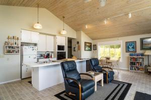 a kitchen with a counter and chairs in a room at 57 Mud Bay in Islandale