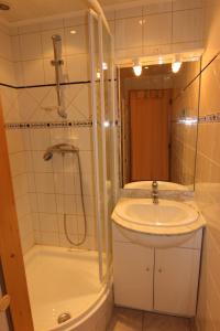 a bathroom with a sink and a shower and a toilet at Beausoleil Appartements VTI in Val Thorens