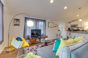 a living room with a blue couch and a kitchen at New Portland Neighborhood Studio in Portland