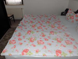 ブルクにあるFerienwohnung Carola Lehmannのベッド(ピンクのバラが敷かれた毛布付)