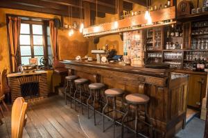 a bar with stools at the counter in a pub at Hotel Zur Post in Wiehl