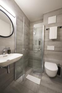a bathroom with a shower and a sink and a toilet at QUARTIER 82 by Arcadeon in Hagen