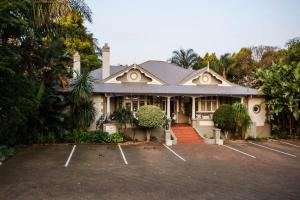 a house with a parking lot in front of it at Oxford Lodge Vryheid in Vryheid