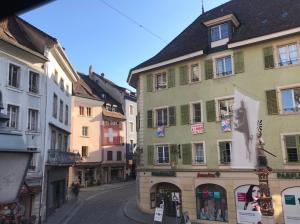 an empty street in a town with buildings at Albergo Diffuso Porrentruy in Porrentruy