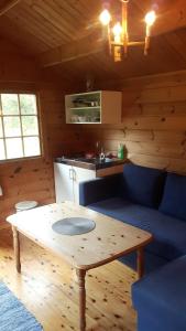 a living room with a table in a cabin at Dalen Gaard camping og hytter in Geiranger