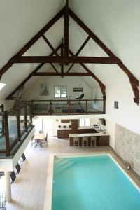 a large room with a swimming pool in a house at Jet d'eau in Montainville