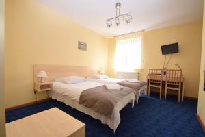 Postel nebo postele na pokoji v ubytování Hotel Tomas