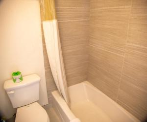 a bathroom with a toilet and a bath tub at Travel Inn in Phoenix