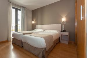Posteľ alebo postele v izbe v ubytovaní Hotel AACR Museo