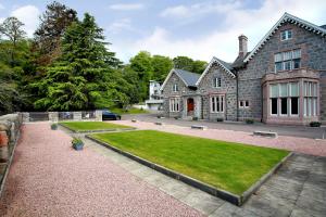 a large house with a lawn in front of it at Luxury Scottish Apartment in Aberdeen