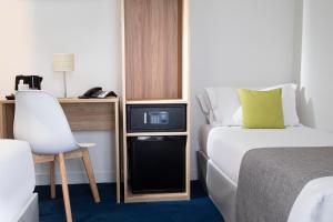 Postel nebo postele na pokoji v ubytování Hôtel Moulin Vert