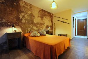 1 dormitorio con 1 cama con colcha de color naranja en Hostal Mont Royal en Alicante