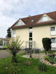 a house with a table and chairs in a yard at Pension Preussenstraße Leipzig in Leipzig