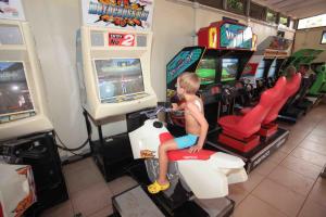 a young boy playing a video game on a scooter at Camping Villaggio Lamaforca in Torre Santa Sabina