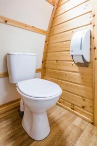 a white toilet in a bathroom with wooden walls at Mains Farm in Stirling