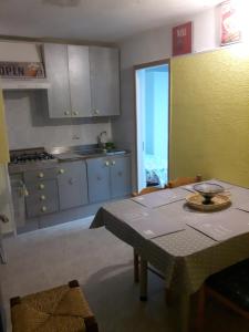 a kitchen with a table and a dining room at pienosole B&B in Francavilla al Mare