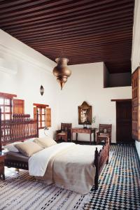 um quarto com uma cama grande e um tecto de madeira em Dar Seffarine em Fez