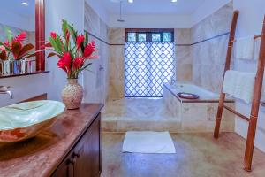 a bathroom with a sink and a bath tub at Makara Rio Suite / Ground Floor in Uvita