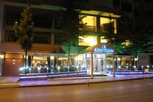 a store on a street at night with lights at Akyuz Hotel in Ankara