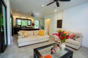 a living room with a couch and a table at Makara Mono Suite / 2nd Floor in Uvita