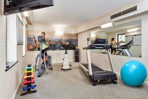 a gym with treadmills and exercise equipment in a room at Orchard Hotel in San Francisco