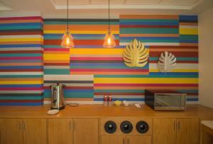 a kitchen with colorful striped walls and a microwave at Concept Hotel - Centro Zamora in Zamora de Hidalgo