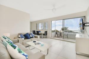 a living room with a couch and a table at Alex Beach Apt Bilgola4 in Alexandra Headland