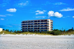 a building on the beach next to a beach at Surfside Condos 204 in Clearwater Beach