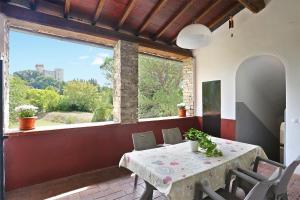 a dining room with a table and a large window at Mondo Pazzo in Rota
