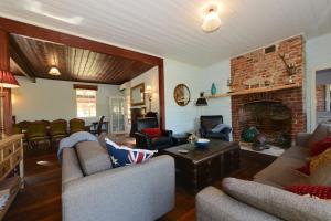 a living room with two couches and a fireplace at Ventnor Guest House in South Bruny