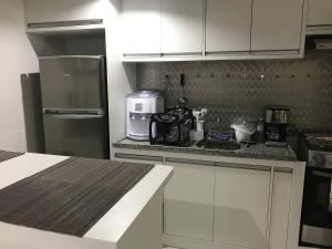 a kitchen with a counter with a coffee maker on it at APTO Bras expo center 25 marco Feirinha Da Madrugada - ESPAÇO INTEIRO in Sao Paulo +17 photos