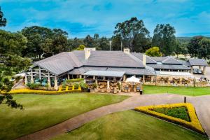 an aerial view of a house with a lawn at Grand Mercure the Vintage, Accor Vacation Club Apartments in Rothbury