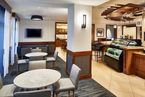 a restaurant with tables and chairs and a video game at Hyatt Place Atlanta/Cobb Galleria in Atlanta