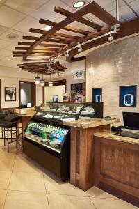 a kitchen with a large display of food on the wall at Hyatt Place Atlanta/Cobb Galleria in Atlanta