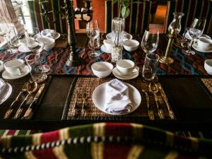 a table with a plate with a napkin on it at Chateau Orientale Resort in Luang Prabang