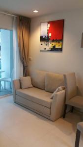 a living room with a couch and a chair at GrandBlue Condominium 201 in Mae Pim