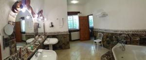 y baño con 2 lavabos, bañera y bañera. en Hotel Villa Lehmi, en Tàrbena