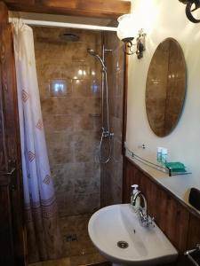 a bathroom with a sink and a shower with a mirror at Ranch pod lesom Slovensky Raj in Spišský Štiavnik +43 photos