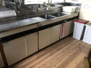 a kitchen with a sink and a counter top at Guest House Itokawa in Matsuzaki