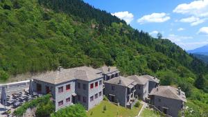 an aerial view of a large house on a mountain at Rouista Tzoumerka Resort in Vourgareli