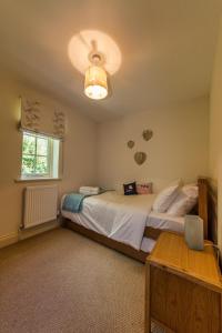 a bedroom with a large bed and a window at Broads Reach in Stalham