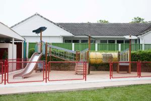 a playground with a slide in front of a house at Chom View Hotel, Hua Hin in Hua Hin