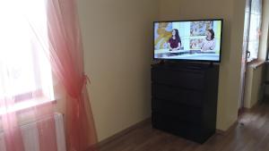 a flat screen tv sitting on a dresser in a room at Sauliaus apartamentai in Panevėžys