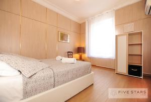 a bedroom with a white bed and a window at Suite Gioia five stars holiday house in Nice